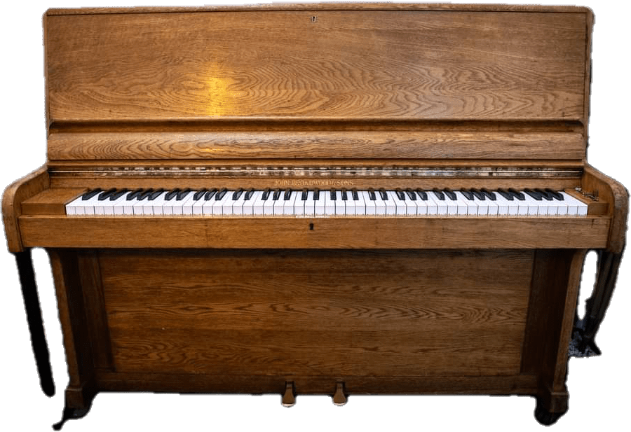 An upright piano with a warm wooden finish, featuring white and black keys and three pedals at the bottom. Hauled away by Wilk's Junk Service.