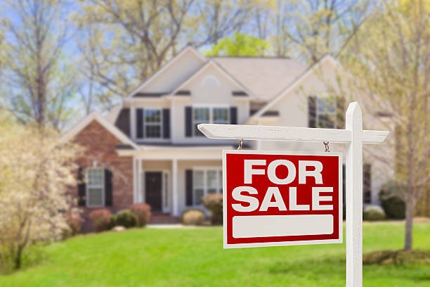 For Sale sign in front of a large suburban house, highlighting Wilk's Junk Service's role in helping real estate agents prepare properties by removing unwanted items and ensuring a clutter-free presentation.
